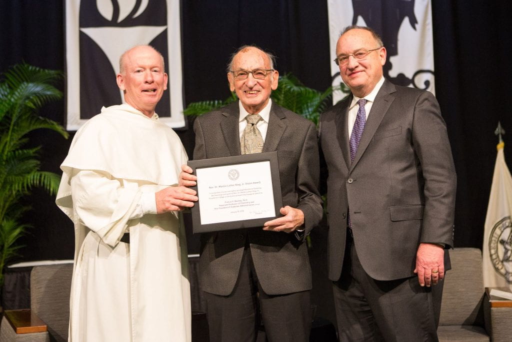 father shanley presenting mlk award to dr. mckay